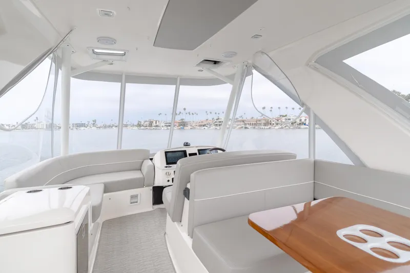Chapter Three Yacht Photos Pics Interior of 2018 Tiara F44 yacht with modern seating and panoramic windows.