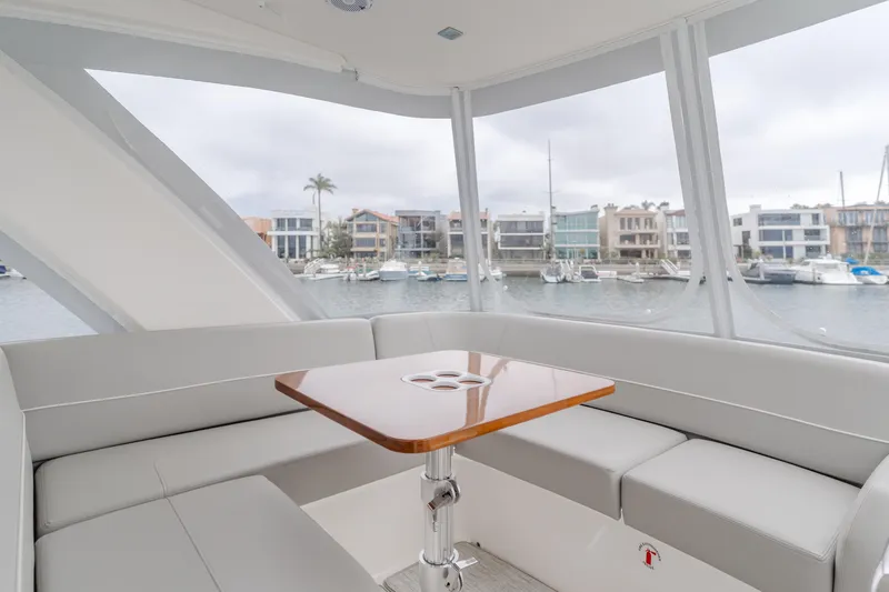 Chapter Three Yacht Photos Pics Interior of 2018 Tiara F44 yacht with elegant seating and marina view.