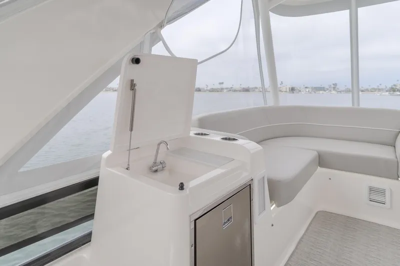 Chapter Three Yacht Photos Pics Interior of 2018 Tiara F44 yacht with sink and seating area.