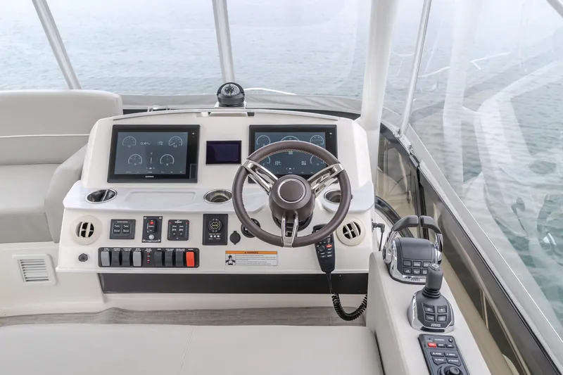Chapter Three Yacht Photos Pics 2018 Tiara F44 yacht helm with modern controls and navigation screens.