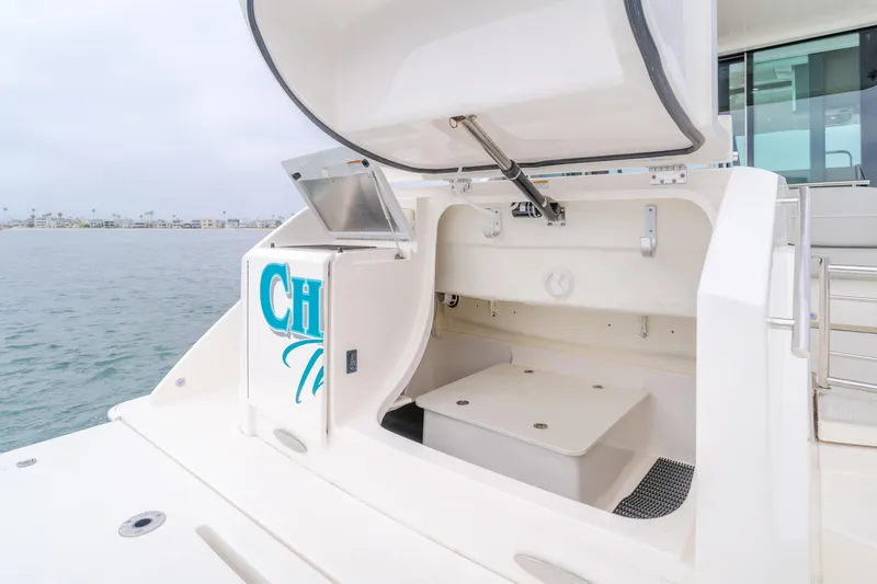 Chapter Three Yacht Photos Pics Open storage compartment on 2018 Tiara F44 yacht, docked by the water.