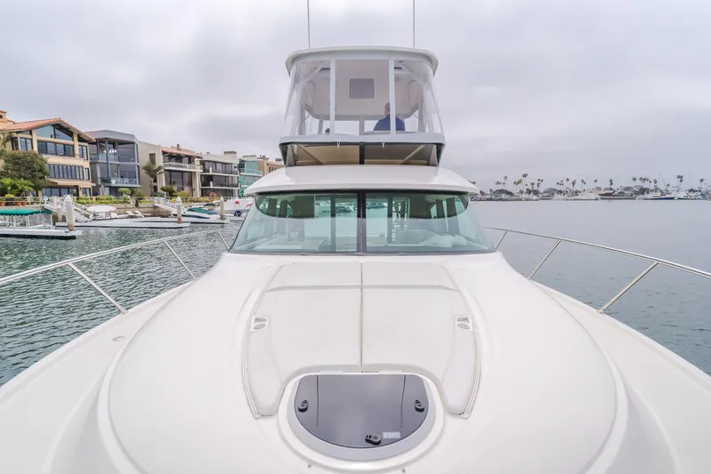 Chapter Three Yacht Photos Pics 2018 Tiara F44 yacht docked in a marina with waterfront homes.