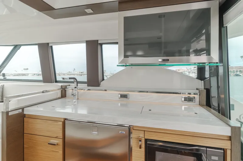 Chapter Three Yacht Photos Pics Modern kitchen interior of 2018 Tiara F44 yacht with sleek countertops and appliances.