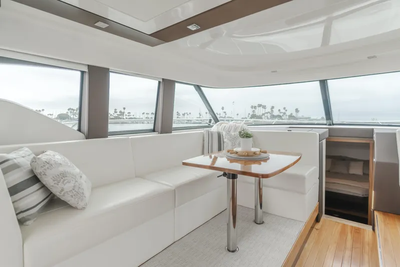 Chapter Three Yacht Photos Pics Luxurious interior of 2018 Tiara F44 yacht with elegant seating and table.