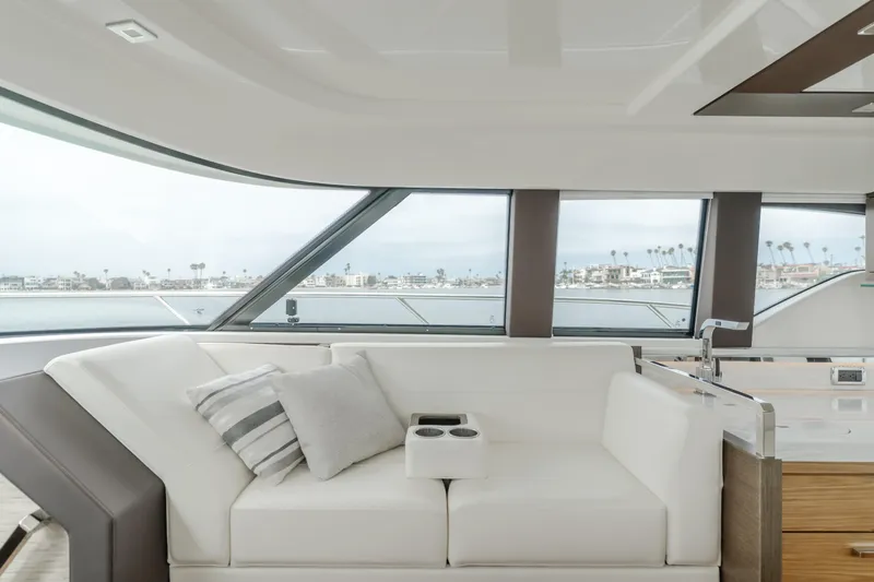 Chapter Three Yacht Photos Pics Luxurious interior of 2018 Tiara F44 yacht with plush seating and ocean view.