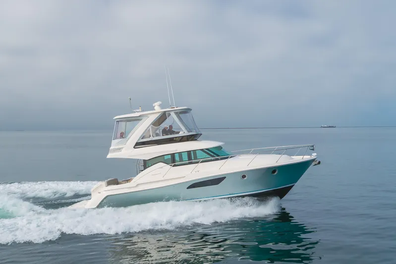 Chapter Three Yacht Photos Pics 2018 Tiara F44 yacht cruising on calm ocean waters.