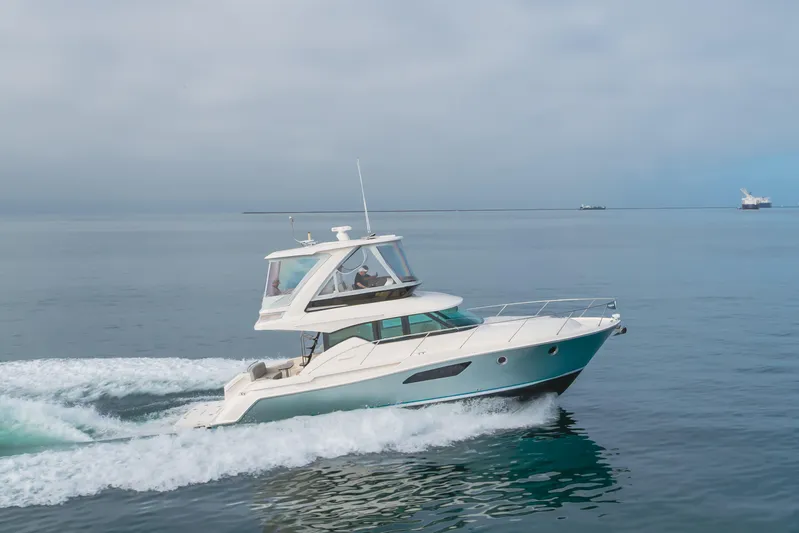 Chapter Three Yacht Photos Pics 2018 Tiara F44 yacht cruising on calm ocean waters.