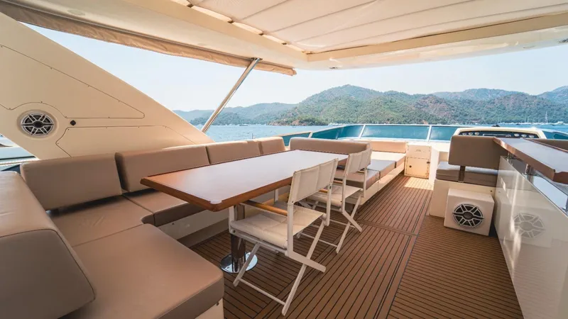  Yacht Photos Pics Luxurious 2013 Azimut 84 yacht deck with seating, table, and scenic ocean view.