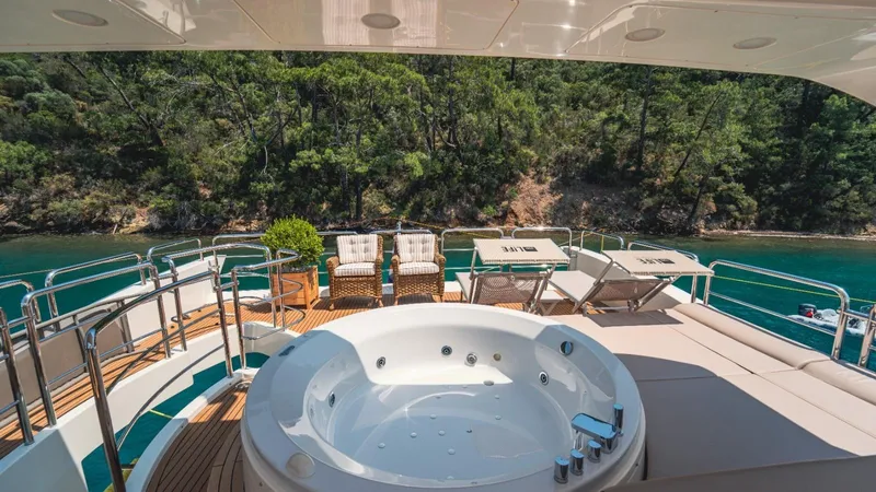  Yacht Photos Pics Luxurious 2013 Azimut 84 yacht deck with jacuzzi, sun loungers, and scenic water view.