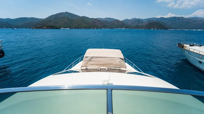  Yacht Photos Pics Azimut 84 yacht cruising on blue waters, scenic mountain backdrop, 2013 model.
