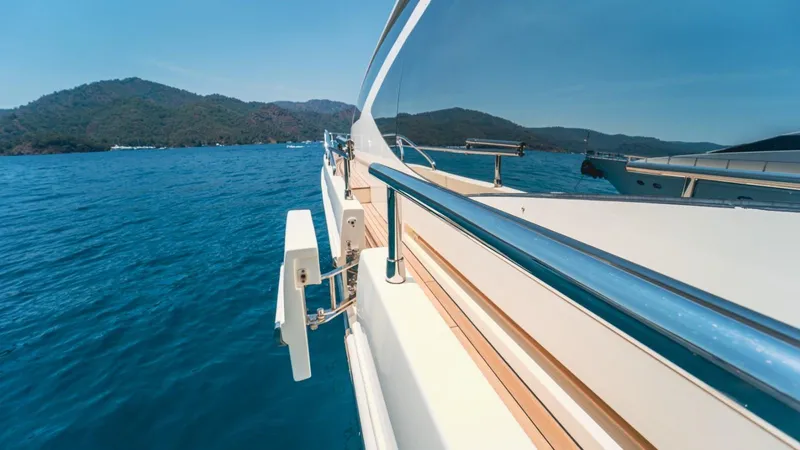  Yacht Photos Pics Azimut 84 yacht cruising on blue waters, 2013 model, scenic mountain backdrop.