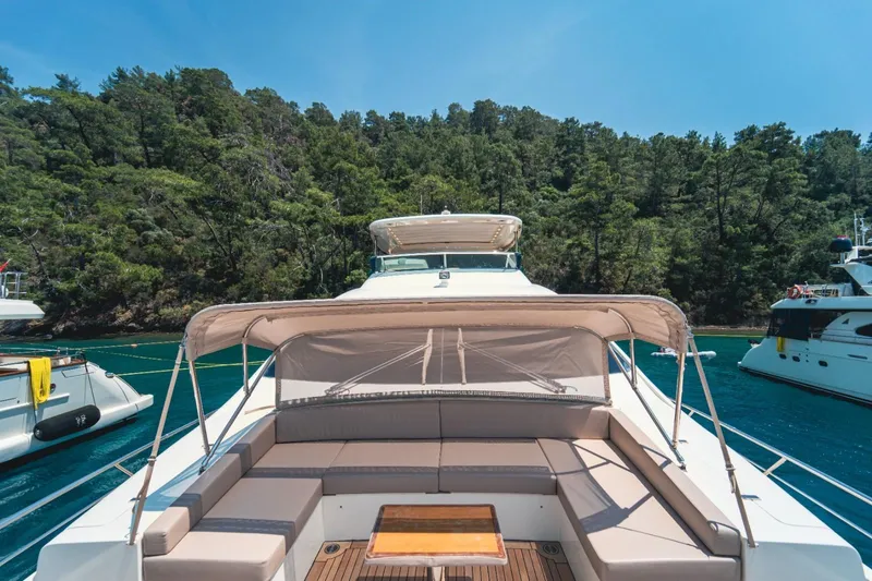  Yacht Photos Pics Luxurious 2013 Azimut 84 yacht with spacious deck seating, surrounded by serene waters and lush greenery.