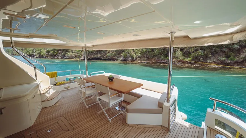  Yacht Photos Pics Luxurious 2013 Azimut 84 yacht deck with seating, overlooking turquoise waters and lush greenery.