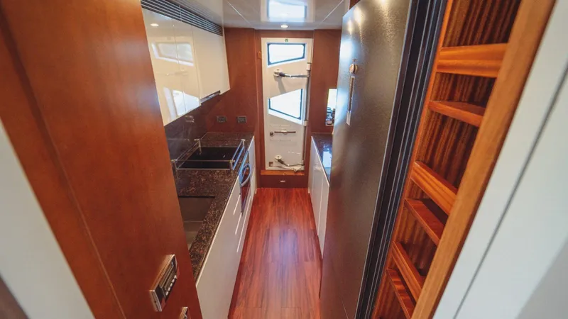  Yacht Photos Pics Luxurious kitchen interior of 2013 Azimut 84 yacht with wood accents and modern appliances.