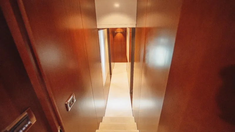  Yacht Photos Pics Interior hallway of 2013 Azimut 84 yacht with wooden paneling and stairs.