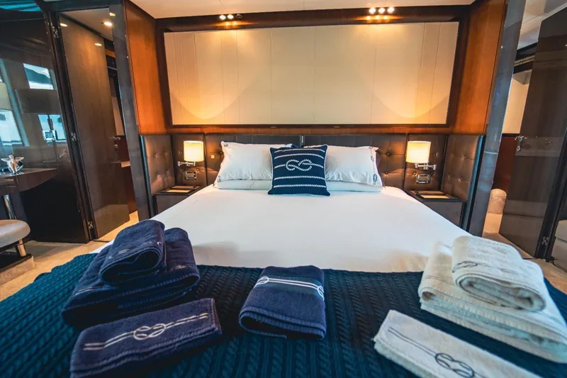  Yacht Photos Pics Luxurious bedroom interior on a 2013 Azimut 84 yacht with elegant bedding and towels.