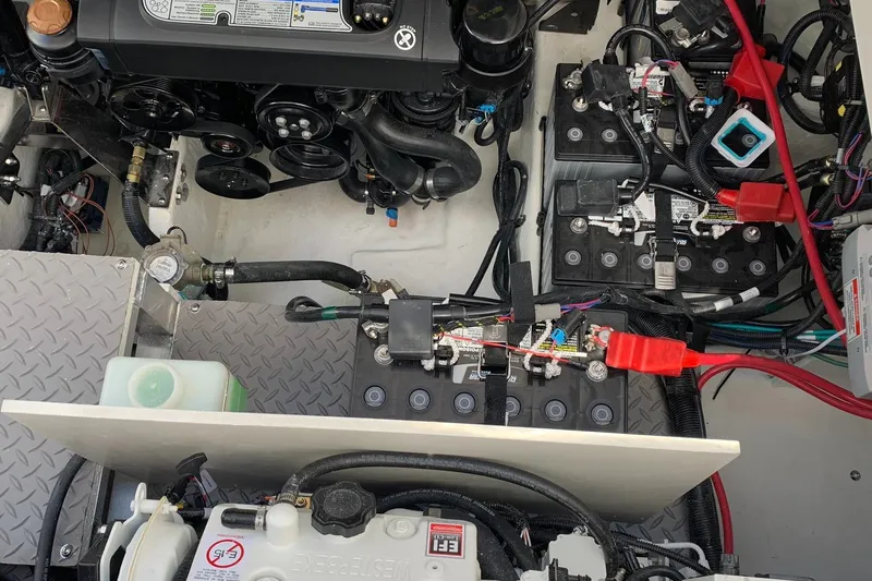 Sortuda Yacht Photos Pics Engine compartment of a 2020 Sea Ray Sundancer 320 boat with visible batteries and wiring.