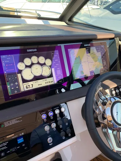 Sortuda Yacht Photos Pics 2020 Sea Ray Sundancer 320 dashboard with Simrad navigation system and steering wheel.
