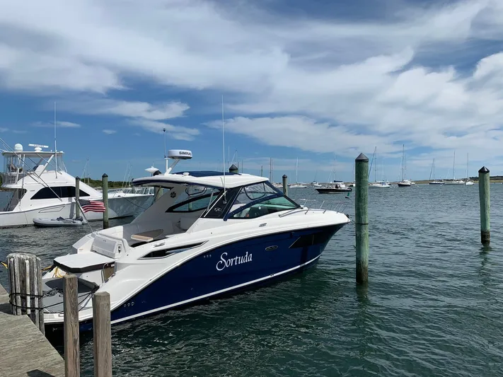 Sortuda Yacht Photos Pics 2020 Sea Ray Sundancer 320 docked at a marina on a sunny day.