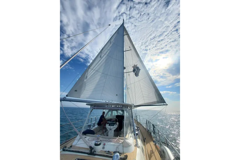 Centurion Yacht Photos Pics Sailing on a 2023 Bluewater 56 yacht under a bright, partly cloudy sky.