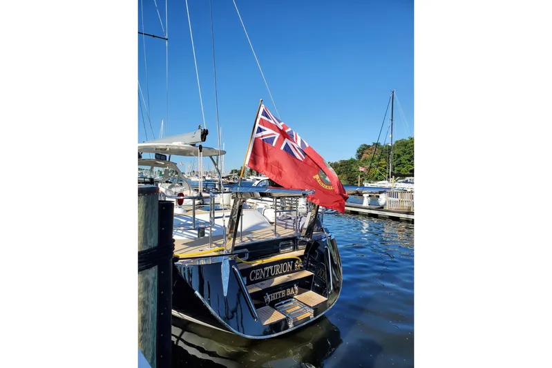 Centurion Yacht Photos Pics 2023 Bluewater 56 yacht docked, featuring a red flag and sleek design.