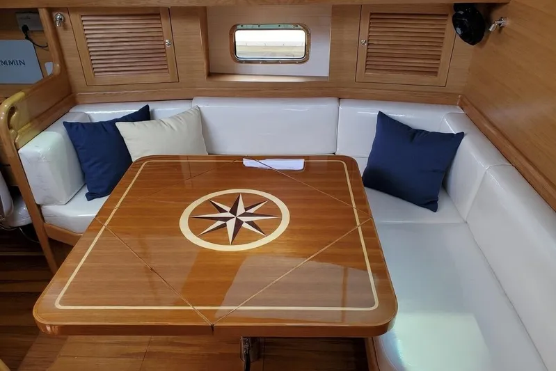 Centurion Yacht Photos Pics Elegant 2023 Bluewater 56 yacht interior with compass rose table and cushioned seating.