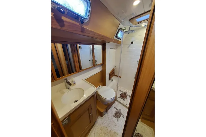 Centurion Yacht Photos Pics Luxurious bathroom in 2023 Bluewater 56 yacht with modern fixtures and elegant wood accents.