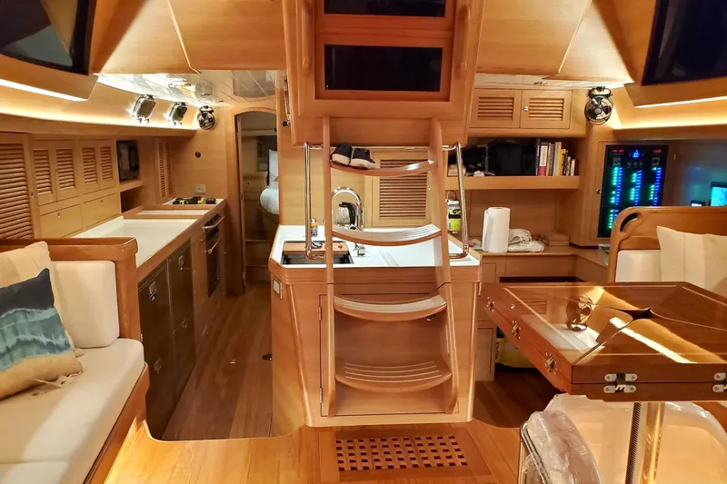 Centurion Yacht Photos Pics Luxurious interior of 2023 Bluewater 56 yacht with modern kitchen and seating area.