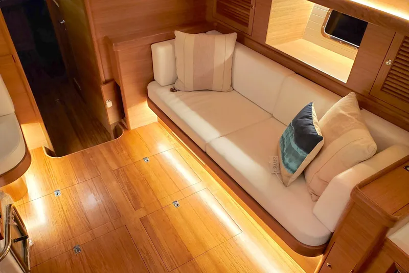Centurion Yacht Photos Pics Luxurious interior of 2023 Bluewater 56 yacht with elegant wood flooring and cozy seating.