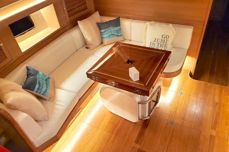 Centurion Yacht Photos Pics Luxurious interior of 2023 Bluewater 56 yacht with elegant wood finish and cozy seating.