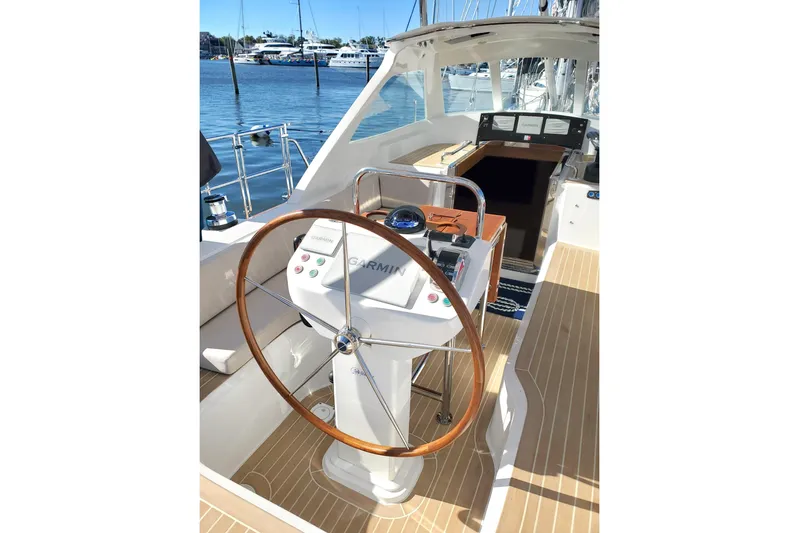 Centurion Yacht Photos Pics Helm of 2023 Bluewater 56 yacht with wooden steering wheel and Garmin navigation.