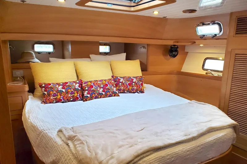 Centurion Yacht Photos Pics Luxurious cabin interior of 2023 Bluewater 56 yacht with cozy bedding and vibrant pillows.