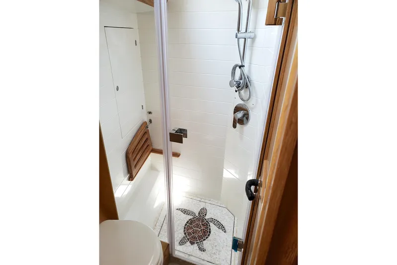 Centurion Yacht Photos Pics Modern shower in 2023 Bluewater 56 yacht with turtle mosaic floor design.