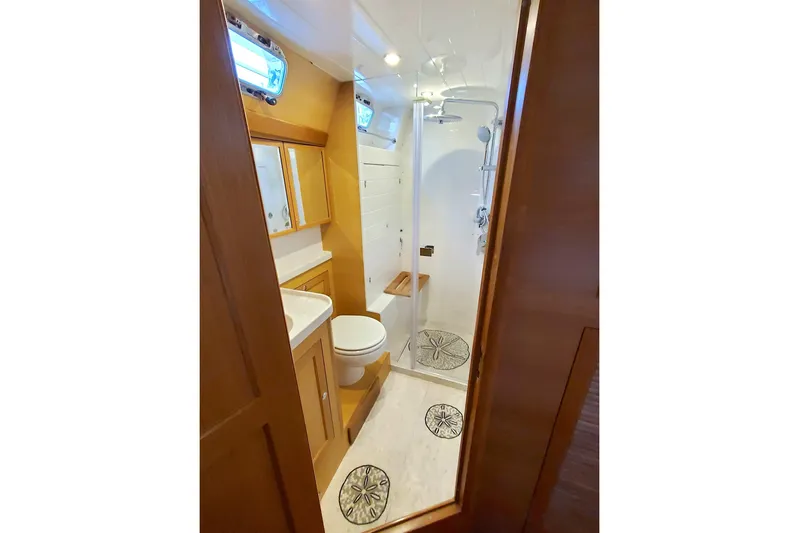 Centurion Yacht Photos Pics Luxurious bathroom in 2023 Bluewater 56 yacht with modern fixtures and wooden accents.