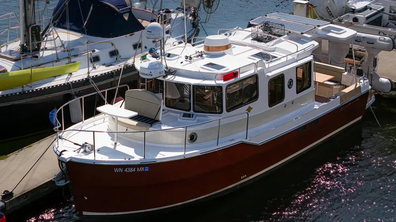  Yacht Photos Pics 2023 Ranger Tugs R-31 S boat docked at marina, featuring classic design and modern amenities.