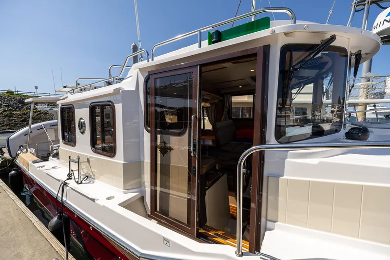  Yacht Photos Pics 2023 Ranger Tugs R-31 S boat docked, showcasing exterior and cabin entrance.