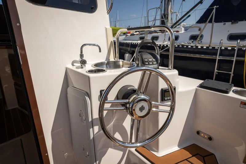  Yacht Photos Pics 2023 Ranger Tugs R-31 S helm with stainless steel wheel and sink.