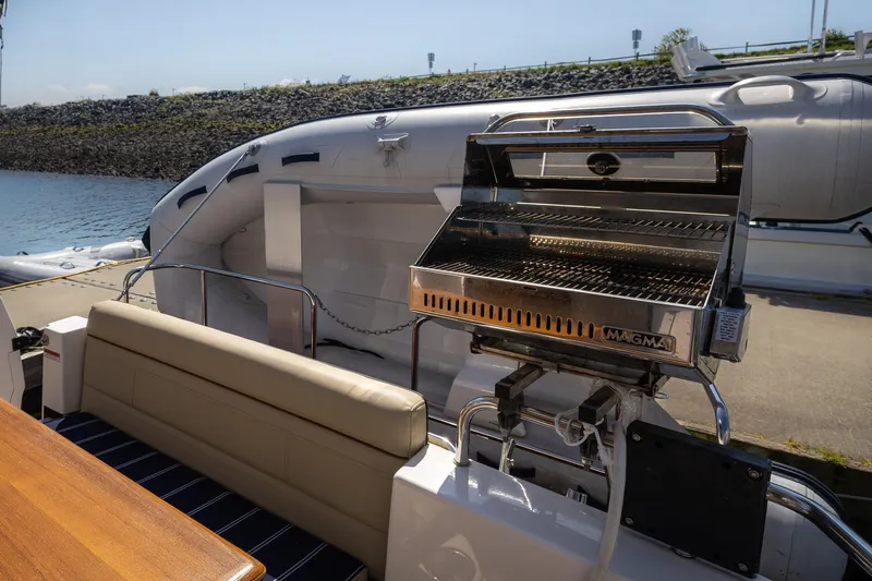  Yacht Photos Pics 2023 Ranger Tugs R-31 S boat with outdoor grill and seating area.