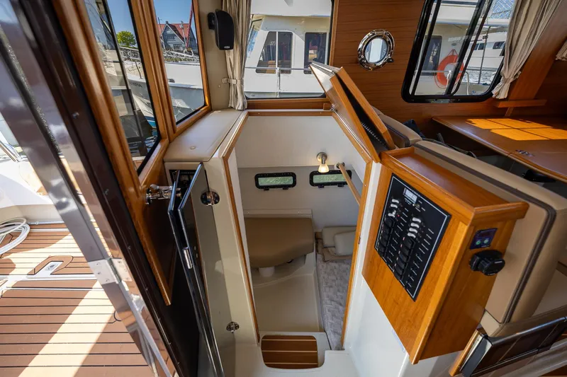  Yacht Photos Pics 2023 Ranger Tugs R-31 S interior with wood accents and control panel.