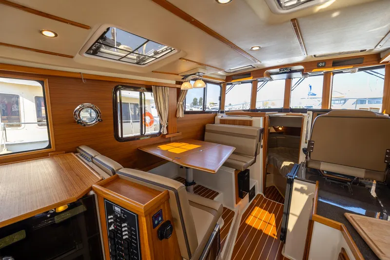 Yacht Photos Pics Interior of 2023 Ranger Tugs R-31 S, featuring elegant wood finishes and spacious seating.