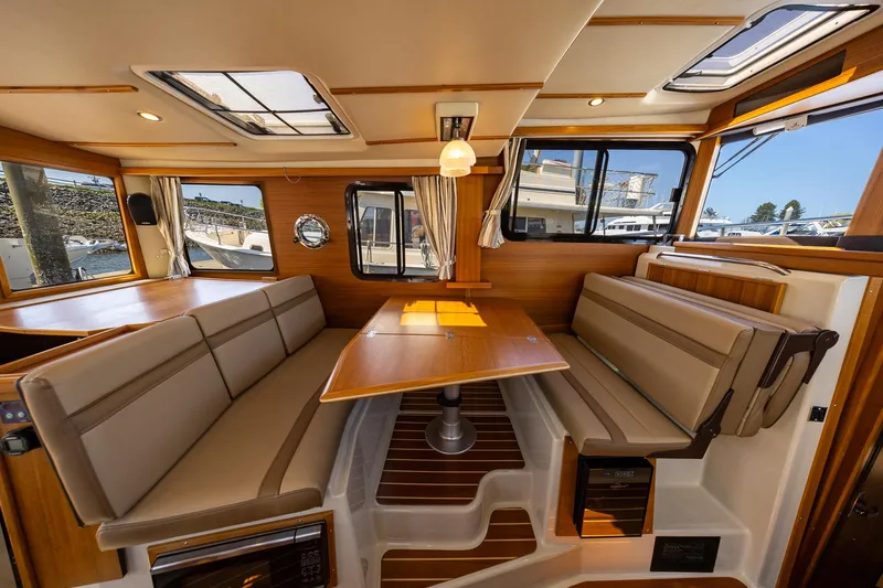  Yacht Photos Pics 2023 Ranger Tugs R-31 S interior with wood accents and spacious seating area.