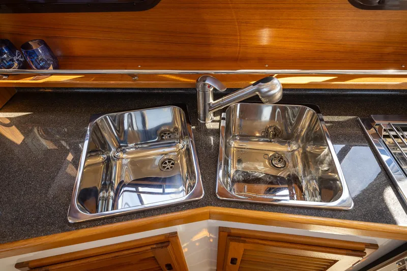  Yacht Photos Pics 2023 Ranger Tugs R-31 S kitchen with dual stainless steel sinks and modern faucet.