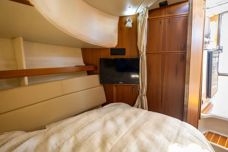  Yacht Photos Pics 2023 Ranger Tugs R-31 S interior cabin with TV and wooden cabinetry.