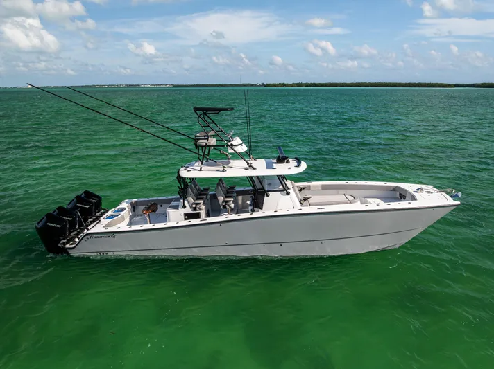  Yacht Photos Pics 2024 Freeman 42 LR boat on turquoise water, featuring multiple outboard engines.