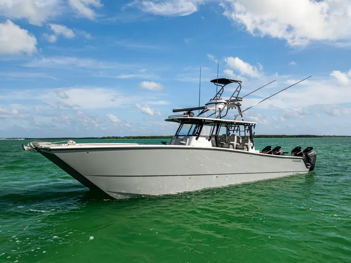  Yacht Photos Pics 2024 Freeman 42 LR boat on clear green water under blue sky.