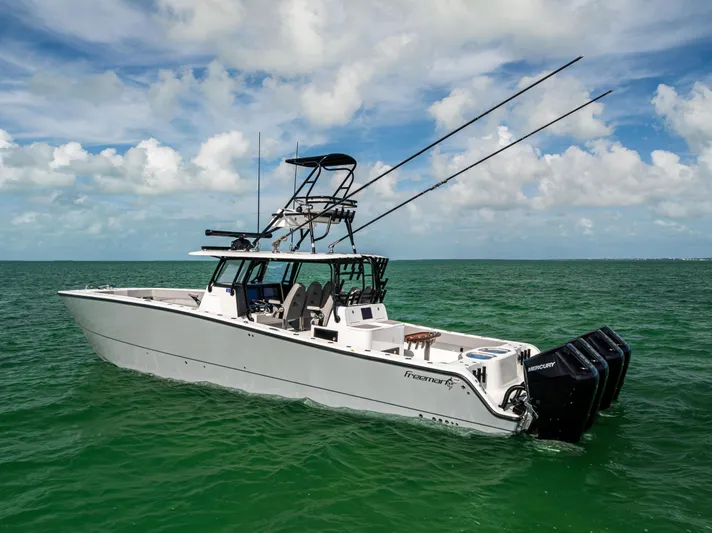 Yacht Photos Pics 2024 Freeman 42 LR boat on open water, featuring dual outboard motors and fishing equipment.