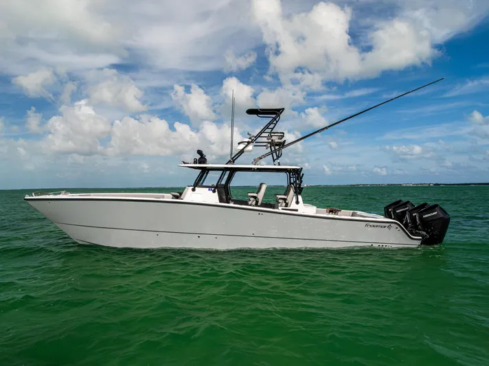  Yacht Photos Pics 2024 Freeman 42 LR boat on calm ocean waters under a partly cloudy sky.