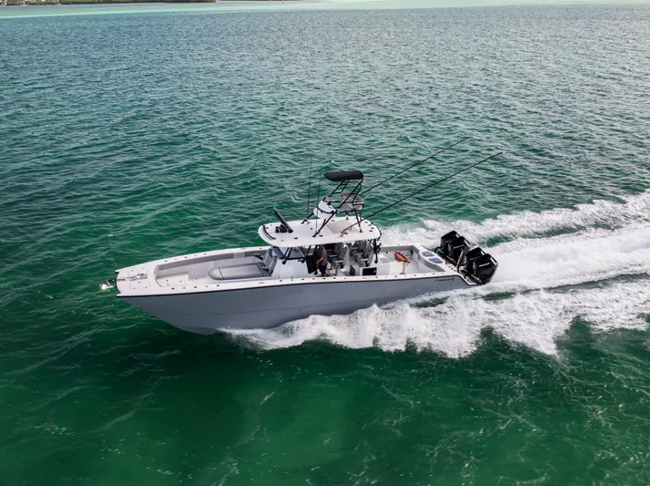  Yacht Photos Pics 2024 Freeman 42 LR boat cruising on clear turquoise waters.