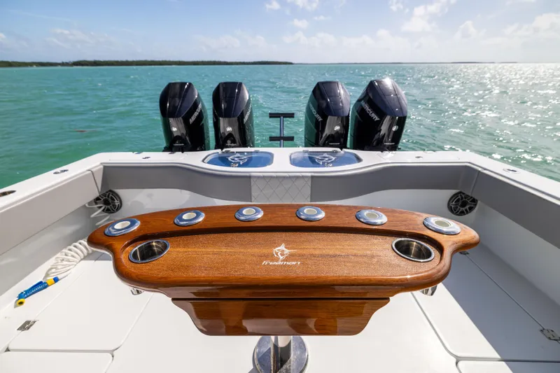  Yacht Photos Pics 2024 Freeman 42 LR boat with four engines, wooden console, and ocean backdrop.