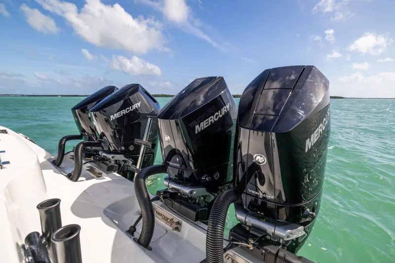 Yacht Photos Pics Four Mercury outboard engines on a 2024 Freeman 42 LR boat in clear blue water.